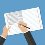 Hands over an open lined notebook, correcting text errors with a red pen. (Copyright: dvolkovkir1980 © 123RF.com)