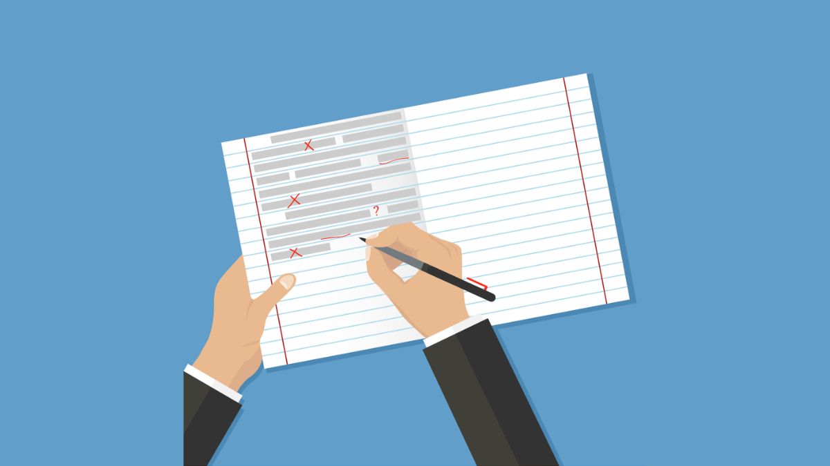 Hands over an open lined notebook, correcting text errors with a red pen. (Copyright: dvolkovkir1980 © 123RF.com)
